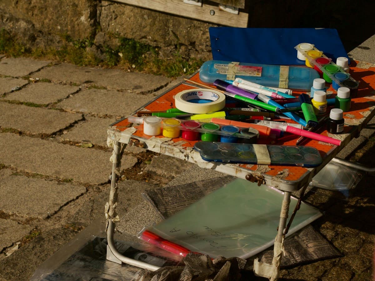 Art supplies like paints and markers on a small table